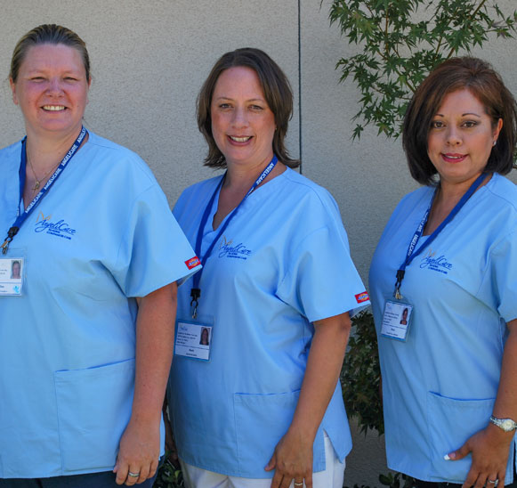 Three caregiver women in Angelicare smocks.